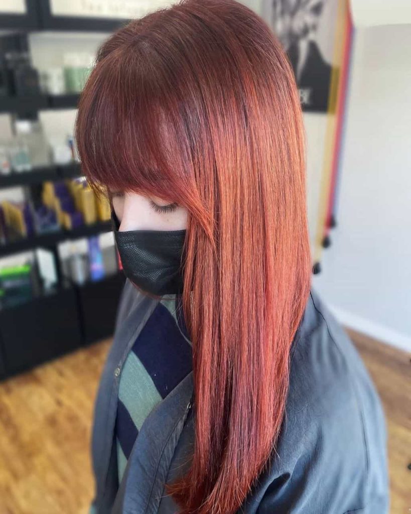 A woman with freshly colored red hair at Cutting Loose Salon